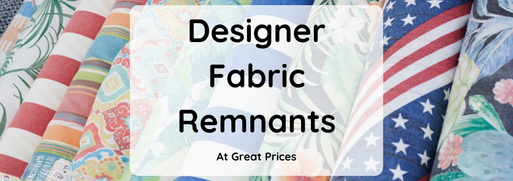 "Designer fabric remnants at great prices". background is a selection of fabric rolls